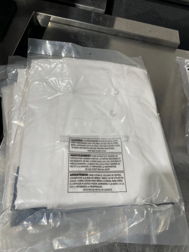 NEW Chef Revival J023XS white chef jacket in packaging, push-thru buttons, tags with care instructions.