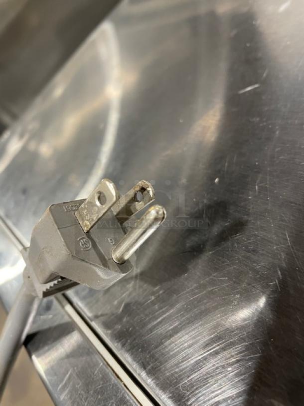 Amana 2021 Model RCS10TS stainless steel countertop microwave oven, electric powered, digital push control, 120V plug shown.