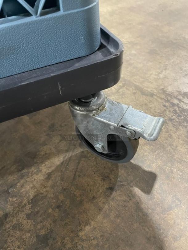 Noble 36-compartment blue cup rack with green extender, mounted on casters. Includes dish dolly. Visible wheel detail.