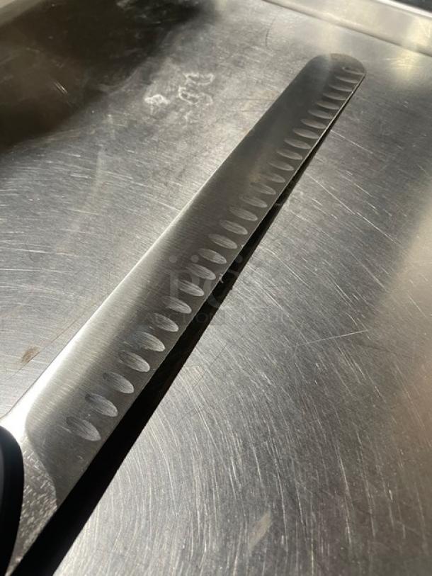 Dexter Russell DuoGlide stainless steel slicer knife with duo-edge blade and black grip handle, new condition.