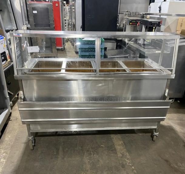 Atlas Metal WIHD&M4 stainless steel 4-well hot food/steam table with sneeze guard, 208V, on casters, commercial use.