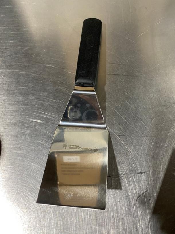 Dexter Russell Sani-Safe stainless steel hamburger turner, 4"x3", model S286-4, with black grip handle, new condition.
