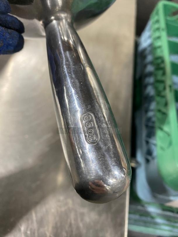 Commercial stainless steel ice scoop, 85 oz capacity, round shape, new condition, stamped "85 oz" on handle.