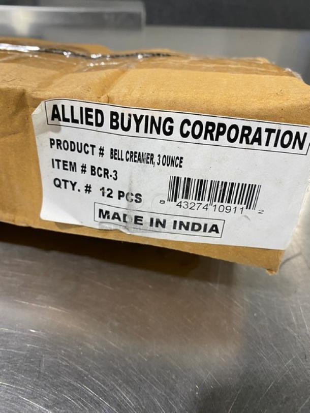 Cardboard box labeled "Allied Buying Corporation," containing ABC Model BCR-3, 3 oz bell creamers, 12 pcs, Made in India.