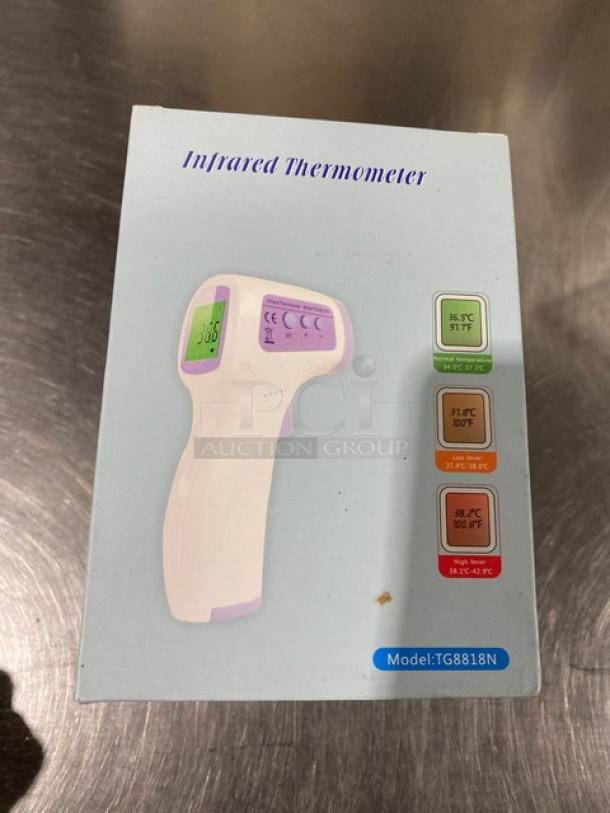 Alt text: "New TG8818N infrared non-contact forehead thermometer in original packaging, displays temperature ranges."