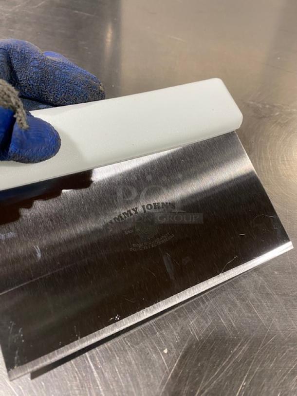 Commercial stainless steel dough cutter, Jimmy John's style, with white grip handle. New condition, visible logo on blade.
