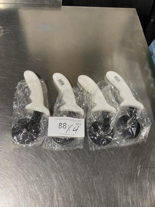 Set of four new commercial stainless steel pizza cutters, model PCP-2, with white grip handles, in packaging.