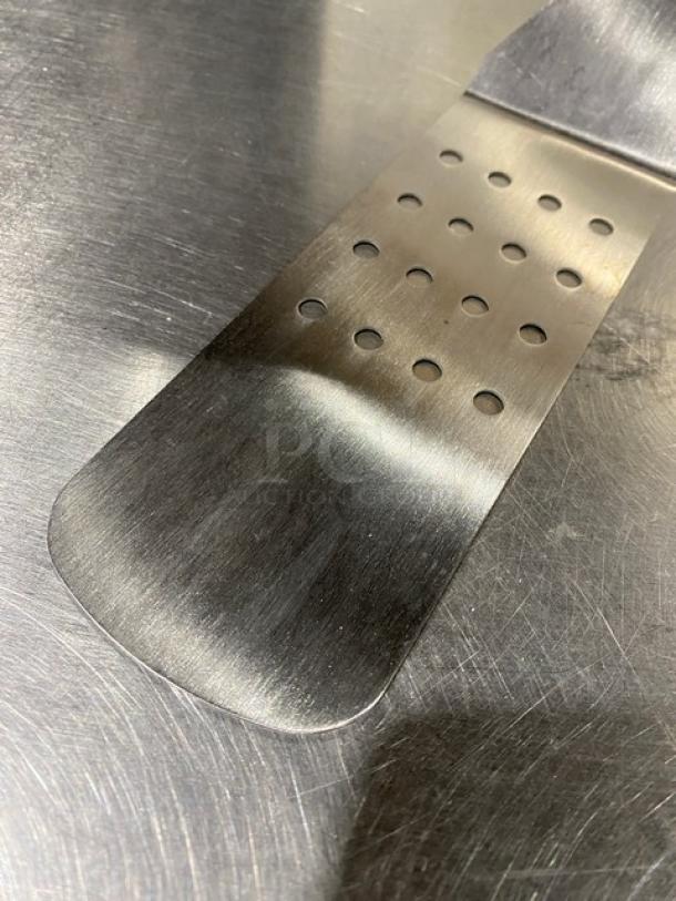 Commercial stainless steel perforated flex turner, Model PFT10P, with white grip handle. New condition.