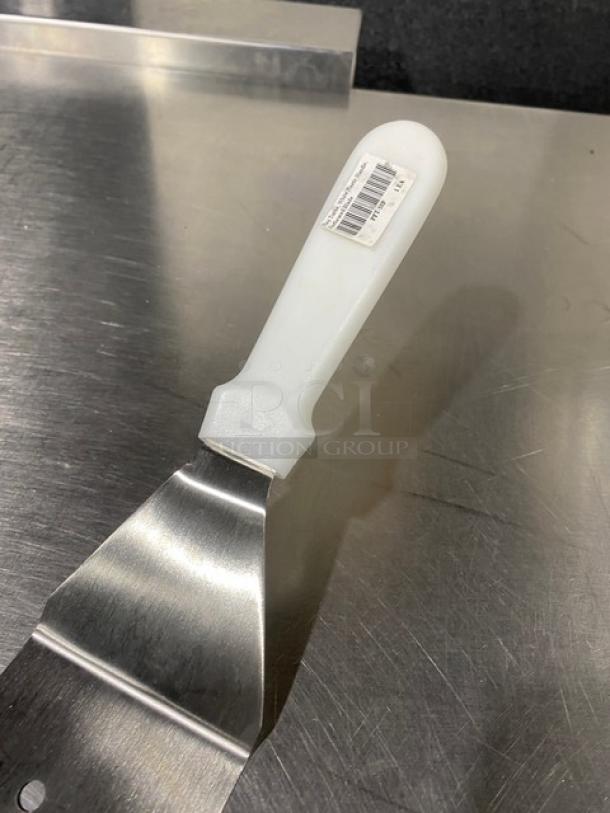 Commercial stainless steel perforated flex turner, model PFT10P, new condition, with white grip handle and visible barcode.