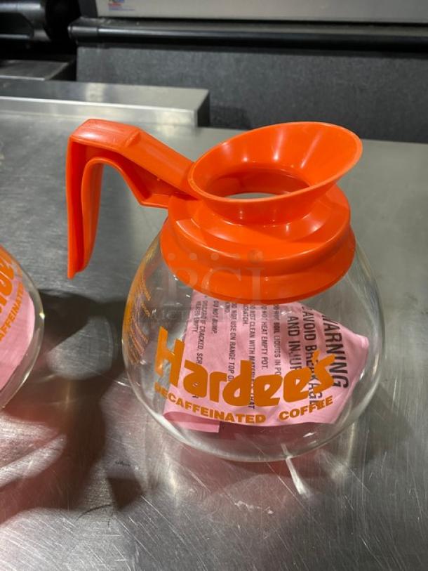 Duran Hardee's glass coffee decanter with orange handle, marked "Decaffeinated Coffee." New condition, commercial grade.