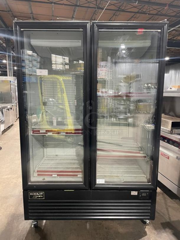 Kool-It commercial double glass door freezer, model 163LX46FB, on casters, with poly coated wired racks, black finish.