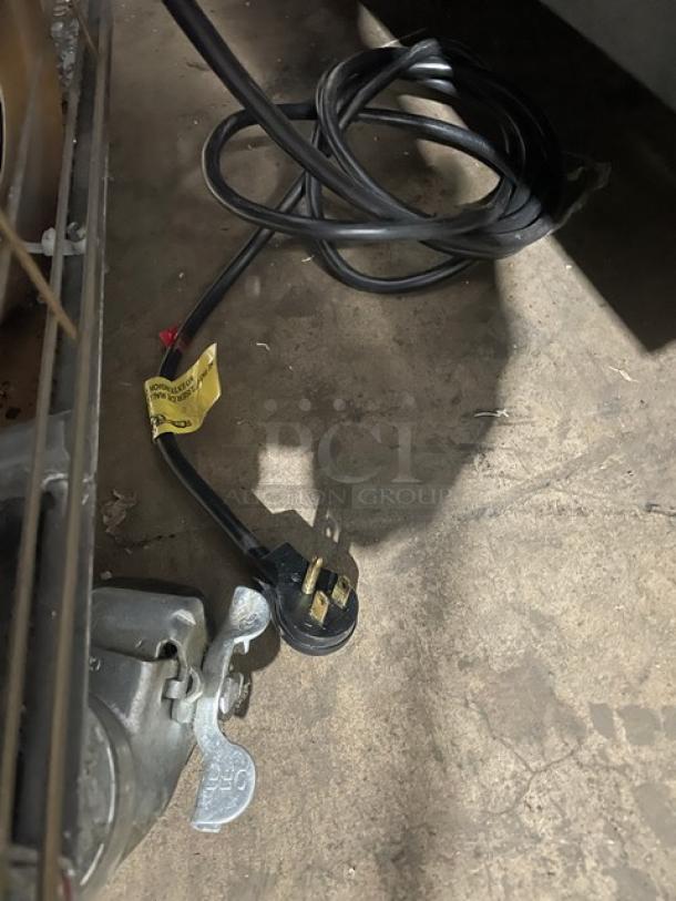 Electric cord and plug for Kool-It Commercial Double Glass Door Freezer, Model 163-LX-46FB, shown on a concrete floor.