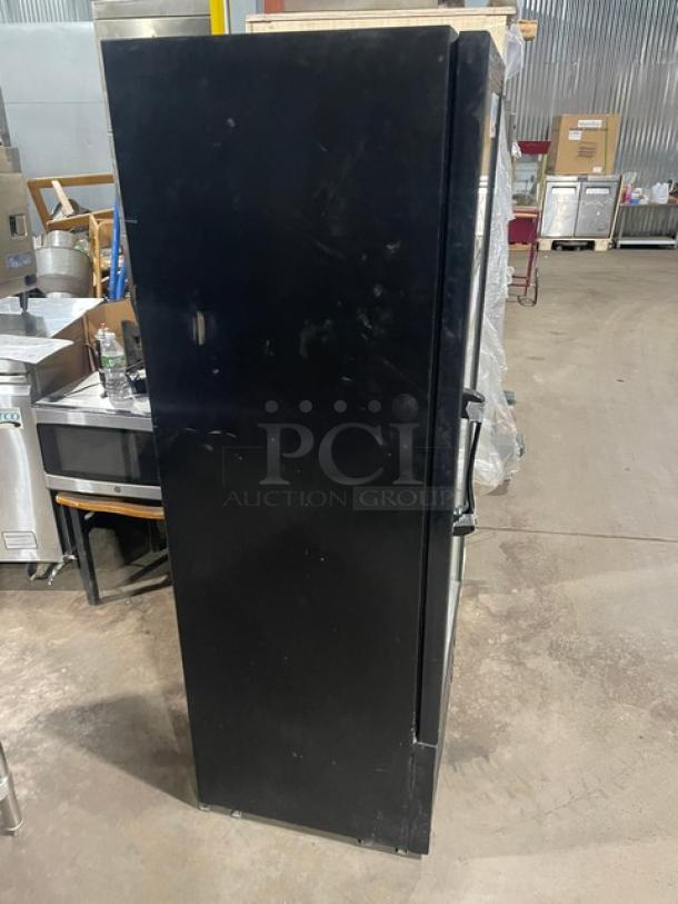 Avantco black swing glass door refrigerated merchandiser, model 178GDC10, with poly-coated wired racks, 115V, on legs.