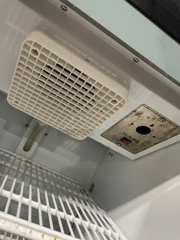 Avantco Model 178GDC10 refrigerated merchandiser interior, featuring poly-coated wired racks and a swing glass door.