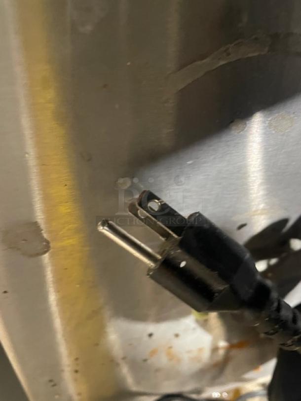 Electric plug of Avantco Model 178GDC10 refrigerated merchandiser, visible against a metal surface.