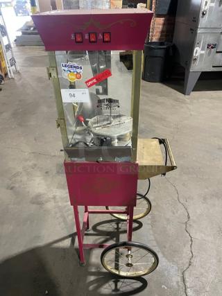 Great Northern Popcorn pink popcorn machine on casters and legs, features control switches, model signage, used condition.