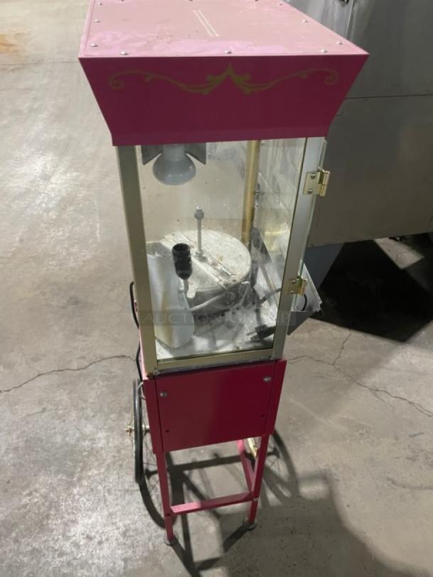 Great Northern Popcorn pink electric popcorn machine on casters and legs, commercial grade, with glass enclosure, good condition.