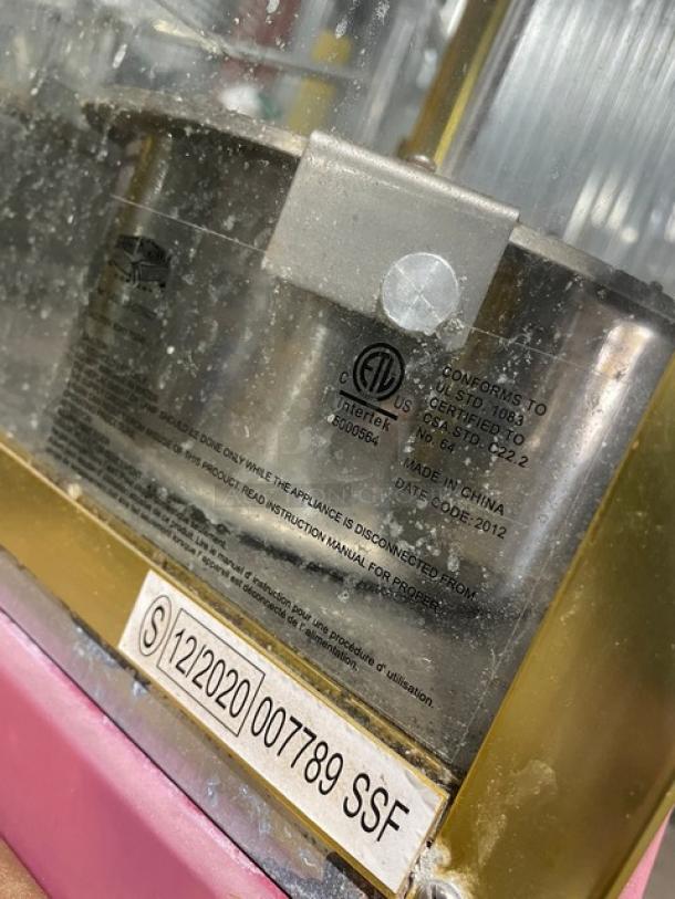 Great Northern Popcorn pink electric popcorn machine, model with casters & legs. Visible label: made in China, date code 2012.