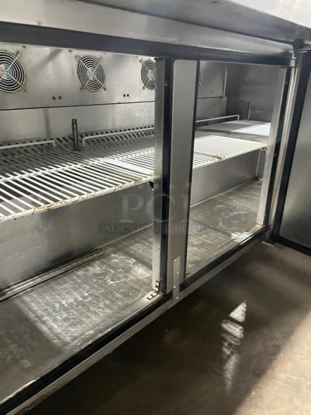 Atosa Mega Top Series 3-door stainless steel prep table, model MSF8308GR, with casters, interior view showing shelves.