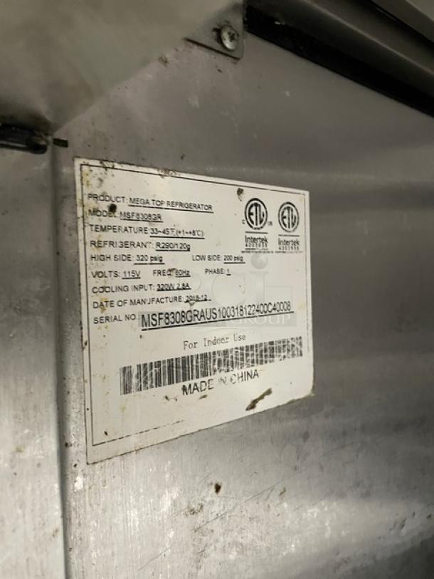 Atosa Mega Top Series 3 Door Refrigerated Prep Table, Model MSF8308GR, 115V, on casters, with visible serial label.