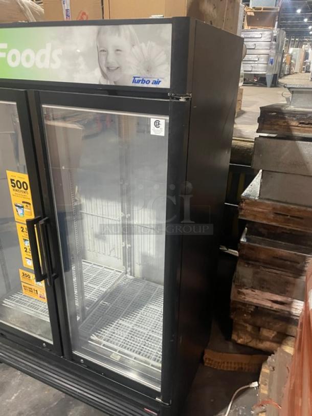 Turbo Air TGF-47SDB-N commercial freezer, black, electric, dual glass doors, poly-coated racks, good condition.