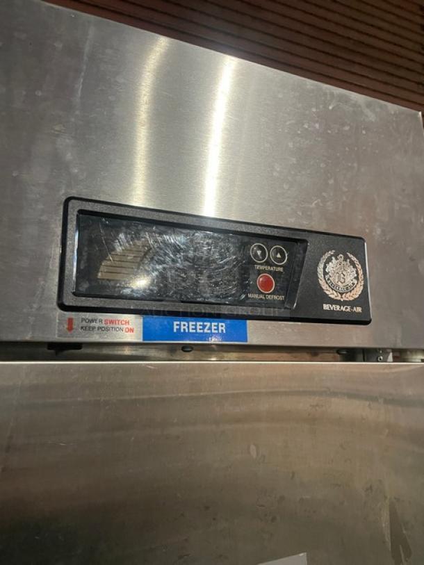 Beverage-Air stainless steel 2-door reach-in freezer, Model KF48-1AS, with poly-coated racks. Features temperature controls and manual defrost label.