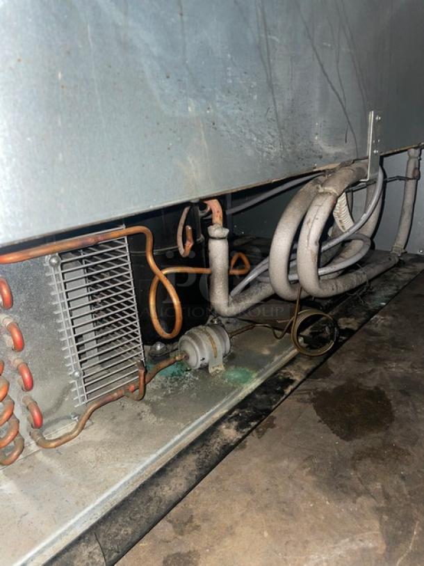 Beverage-Air KF48-1AS commercial freezer, electric, stainless steel, showing internal components and wiring, indicating function.