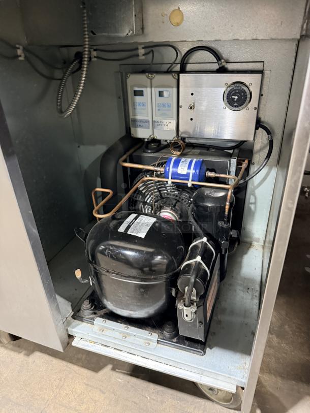 Traulsen TRP096S commercial pizza prep table components; features stainless steel design, cutting board, wired racks.