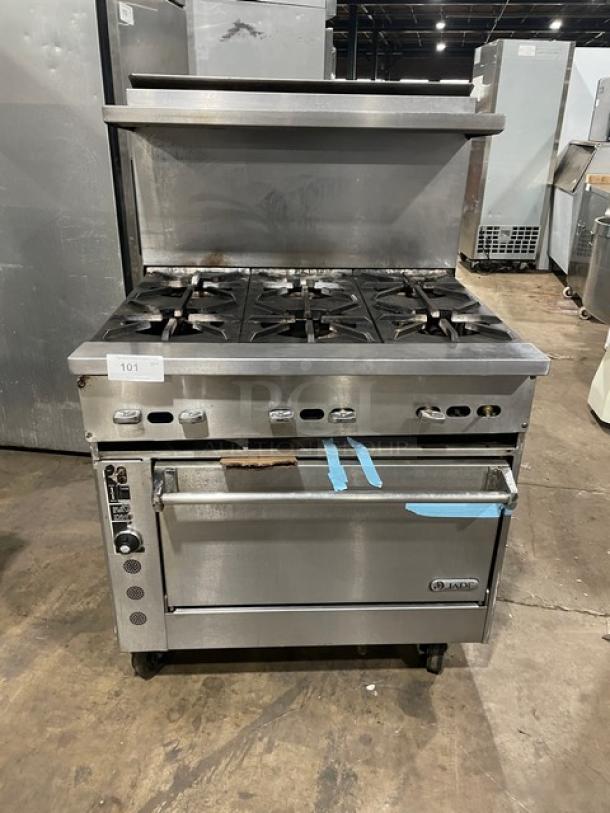 Jade 6-burner natural gas range with stainless steel finish, convection oven, raised backsplash, salamander shelf, on casters.