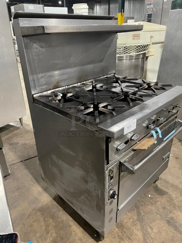 Jade Range heavy duty 6-burner gas range with full-size convection oven, stainless steel, on casters, with backsplash and salamander shelf.