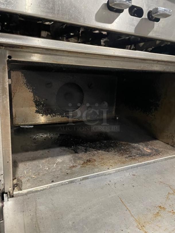 Jade Range stainless steel 6-burner gas stove with convection oven. Features raised backsplash, salamander shelf, on casters.