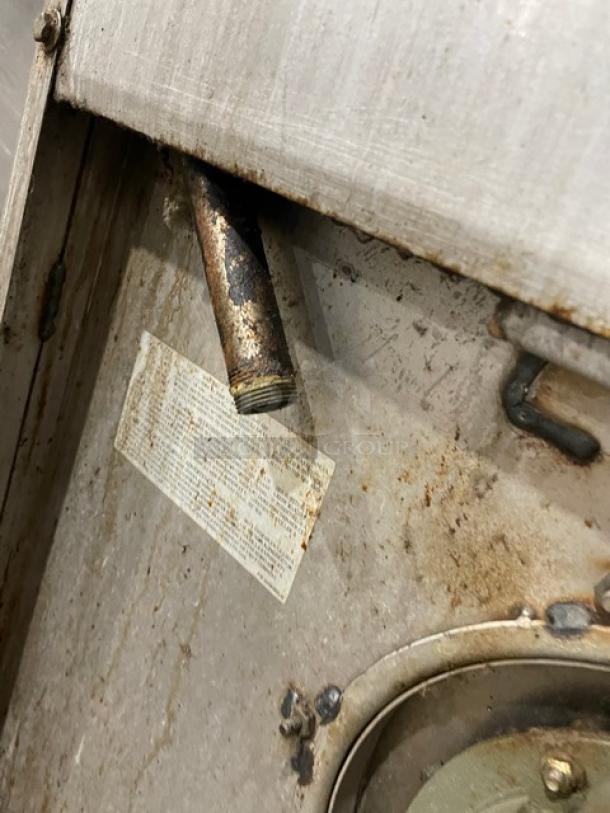 Jade Range natural gas 6-burner with full-size convection oven, stainless steel, raised back splash, salamander shelf, on casters.