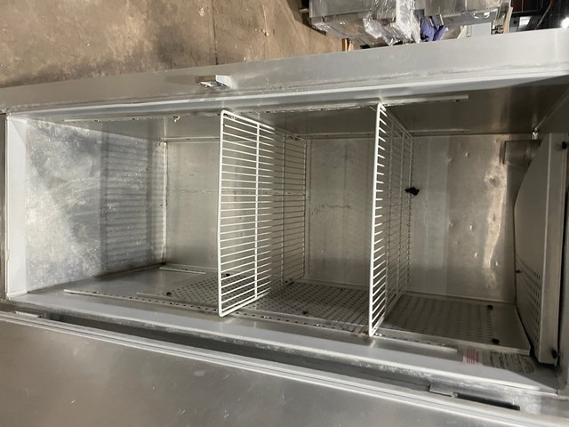Interior of commercial reach-in cooler showing poly-coated racks