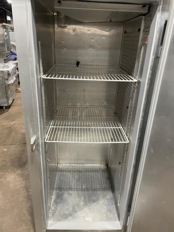 Continental DL1FE stainless steel reach-in freezer, one door, 115V, 1 phase, on legs, shelving inside, model and serial visible.
