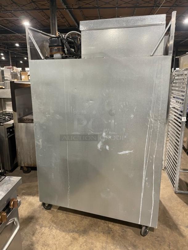 Delfield Model 6051-S 2 solid door reach-in cooler on casters, 115V, showing exterior with visible wear, back view.