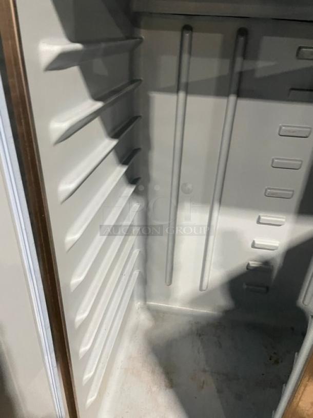 Delfield Model 6051-S 2 Door Reach In Cooler; interior shelving slots, clean condition, on casters, 115V 1 Phase.