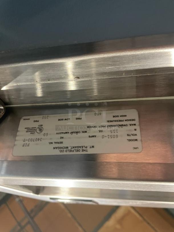 Delfield 6051-S reach-in cooler, model 6051-S, serial 340703-T. 115V 1 phase. Features solid doors, on casters.