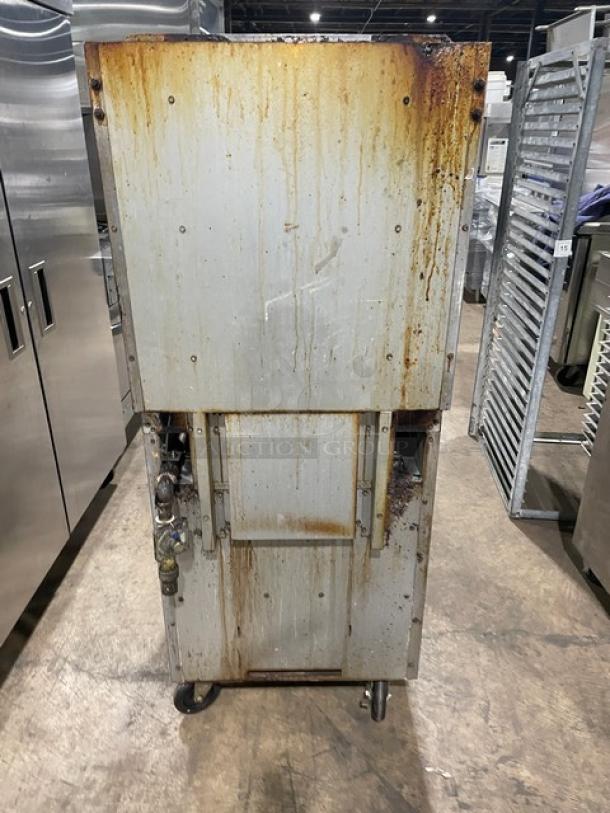 Cooper Beech 4-burner natural gas range with oven, raised backsplash, and casters. Visible wear and rust on metal surface.