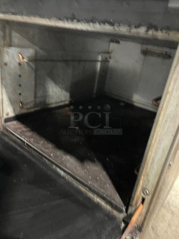 Cooper Beech 4-burner gas range with oven and raised backsplash, on casters, showing the interior cooking area.