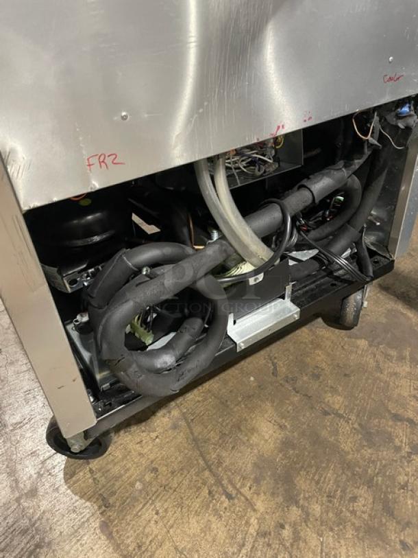 True T23DT split door cooler/freezer combo on casters, model T23DT, serial 7477212, 115V 1 phase. Visible internal components.