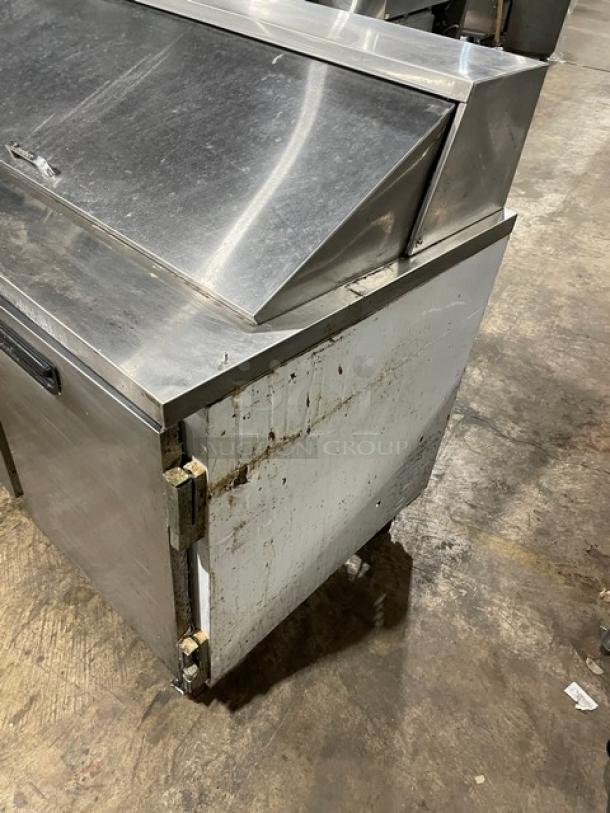 Leader 48" Mega Top Refrigerated Sandwich Prep Table, Model ESLM48S/C. Stainless steel, on casters, signs of wear.