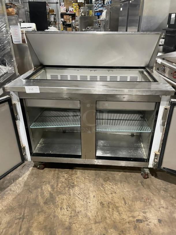 Leader 48" Mega Top Sandwich Prep Table, Model ESLM48S/C, 115V, 1 Phase, on casters. Good condition, visible interior shelves.