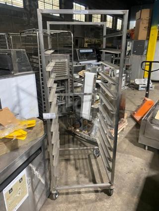 Channel commercial heavy-duty pan holding/transport rack on casters. Stainless steel construction, multiple shelves, in used condition.