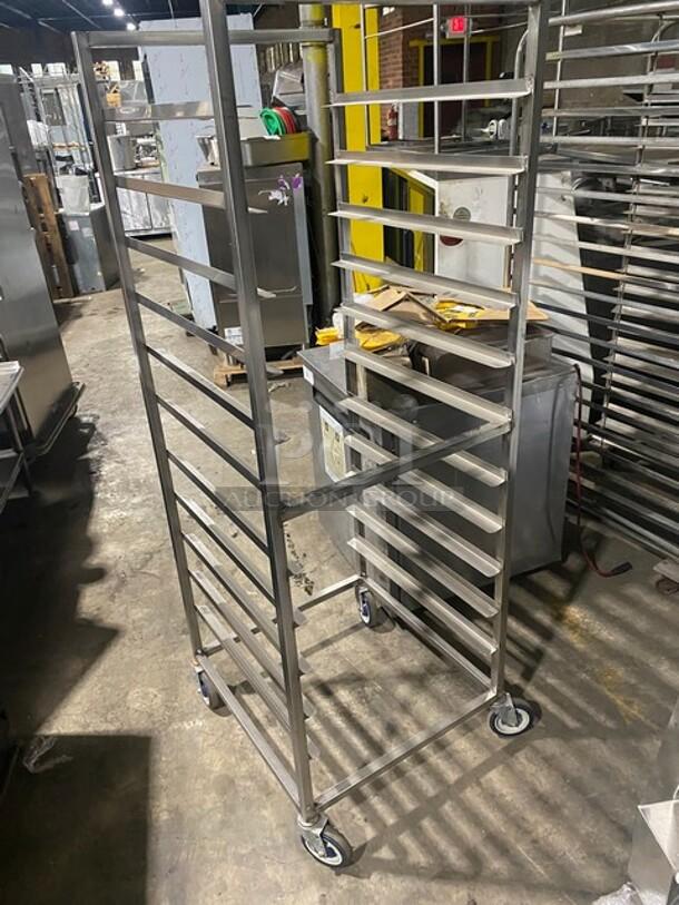 Channel commercial heavy-duty pan holding rack on casters, metal frame, multiple slots, good condition, used for transport.