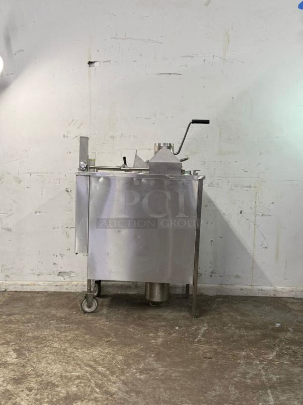 Wells KFC pressure fryer, stainless steel, manual controls, on wheels. Used condition with visible wear.