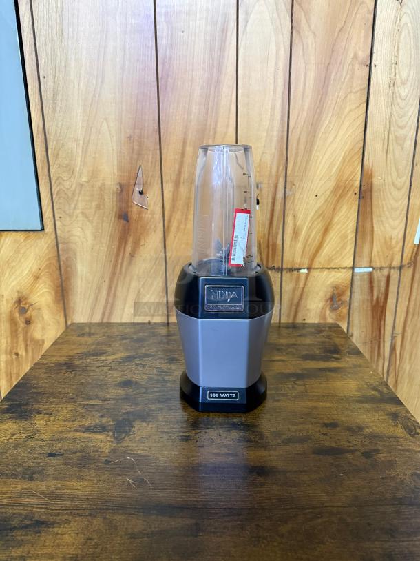 Ninja BL450C Nutri Pro Personal Blender, 900W, black/silver, 18 and 24 oz cups, shown on wooden background.