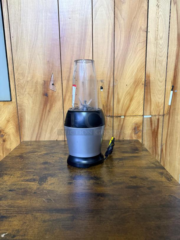 Ninja BL450C Nutri Pro Personal Blender, black/silver, 900W, with 18 and 24 oz cups, shown upright on wood surface.