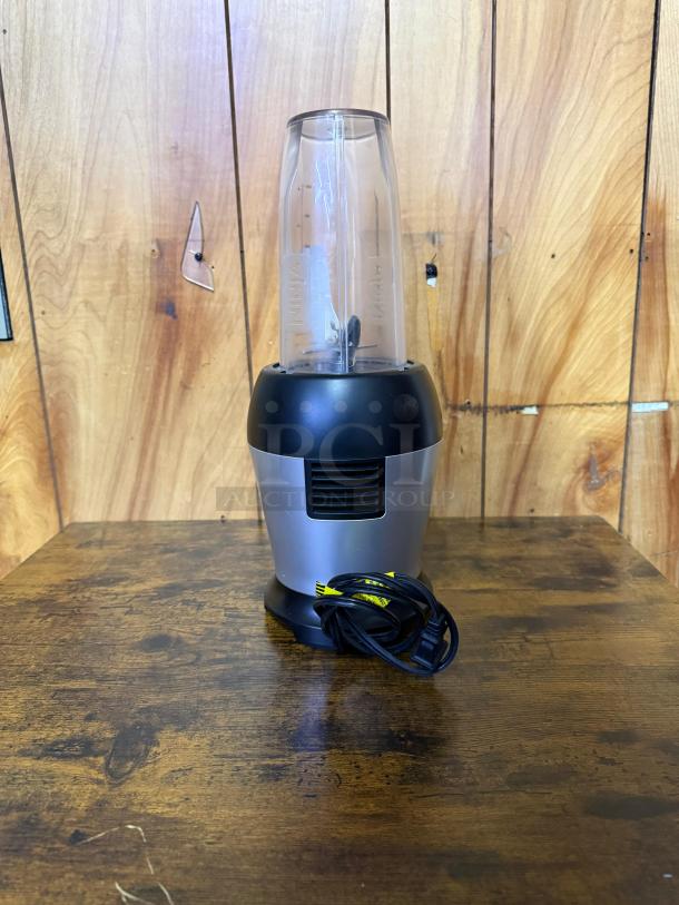 Ninja BL450C Nutri Pro Personal Blender, black/silver, 900W, includes 18 and 24 oz cups, power cord visible, good condition.