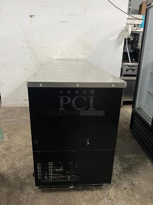 PADELA UBB-4-HC 90" back bar cooler, 3-section, solid doors, stainless top, moderate wear, black exterior, visible vent grille.