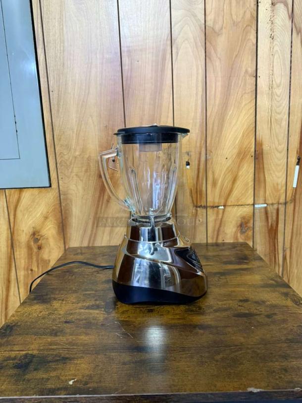 Oster Pro 500 Blender with glass jar and brushed nickel base. In good condition, power cord attached.